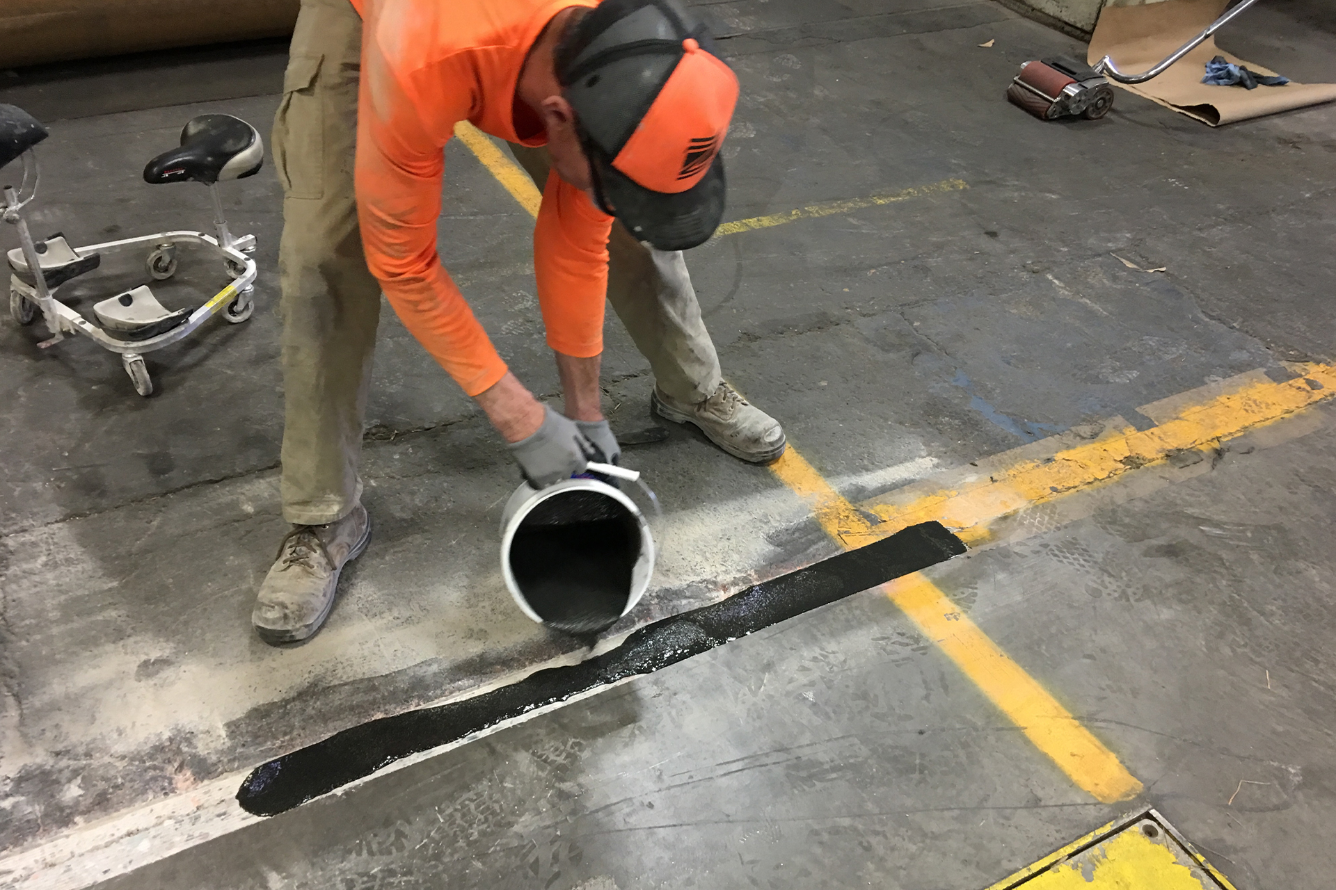 Concrete professional repairing a broken expansion joint